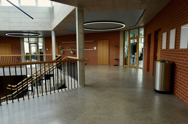 Hallway with a speckled quartz and terrazzo-style floor