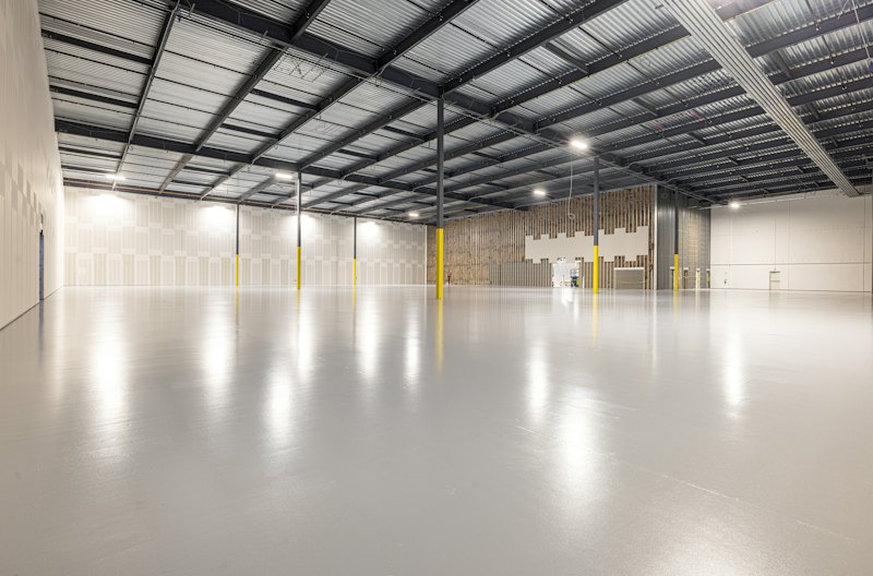 Empty industrial warehouse with a smooth coated floor